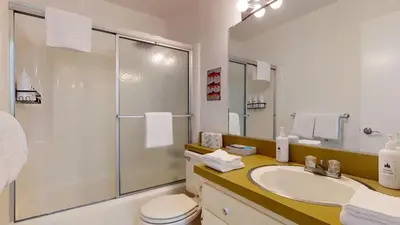 a bathroom with a toilet and a sink and a shower at Sierra Manors #61 condo in Mammoth Lakes