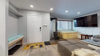 a living room with a couch and a flat screen tv at Sierra Manors #61 condo in Mammoth Lakes