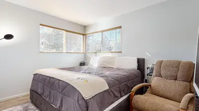 a bedroom with a bed and a chair at Sierra Manors #61 condo in Mammoth Lakes