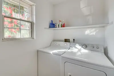 a white washing machine in a white laundry room at 4 Mi to San Joaquin River Peaceful Patterson Home in Patterson