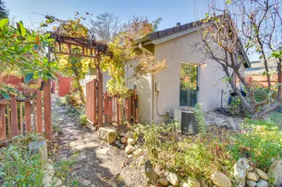 a house with a fence in front of a yard at 4 Mi to San Joaquin River Peaceful Patterson Home in Patterson