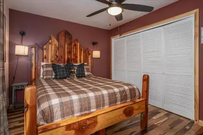 a bedroom with a bed and a ceiling fan at Sequoia's Dream with Mountain View, Spa, Heated Floor, Bar, Cinema! in Oakhurst