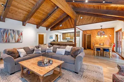 a living room with a couch and a table at Cabin for 8 HotTub Close to Ski Town Private Beach in Tahoe City