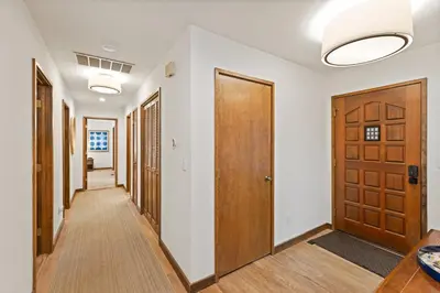 a hallway with wooden doors and wooden floors at Cabin for 8 HotTub Close to Ski Town Private Beach in Tahoe City