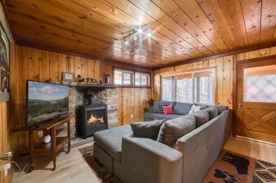 a living room with a couch and a fireplace at Wanderlust Retreat by Tahoe Getaways - 4BR Pet-Friendly w Fenced Yard, Walking Distance to Lake! in Tahoe City