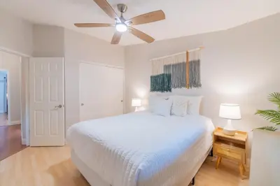 a bedroom with a white bed and a ceiling fan at Modern 3-Bedroom Escape in Northwest Reno in Reno