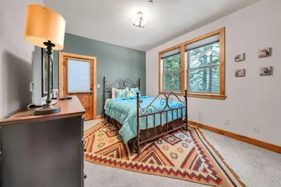 a bedroom with a bed and a desk and window at Spacious Tahoma Retreat with Hot Tub and Game Room in Tahoma