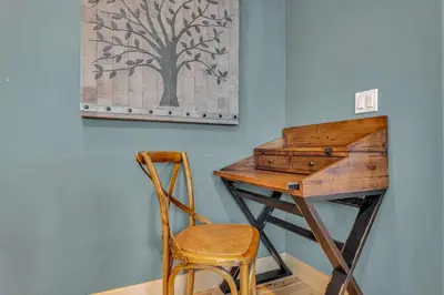 a wooden desk with a chair next to a wall at Spacious Tahoma Retreat with Hot Tub and Game Room in Tahoma