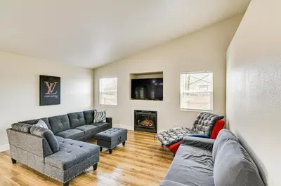 a living room with two couches and a fireplace at 1 Mi to Pioneer Crossing Casino Fernley Retreat! in Fernley