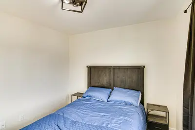 a bedroom with a bed with blue pillows at 1 Mi to Pioneer Crossing Casino Fernley Retreat! in Fernley