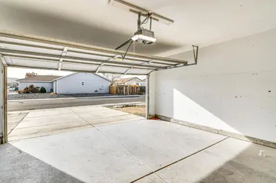 an empty garage with a white wall and a ceiling at 1 Mi to Pioneer Crossing Casino Fernley Retreat! in Fernley