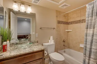 a bathroom with a toilet and a sink and a tub at 3987 - Upscale Townhouse Walk to Heavenly, Casino and Beach in South Lake Tahoe