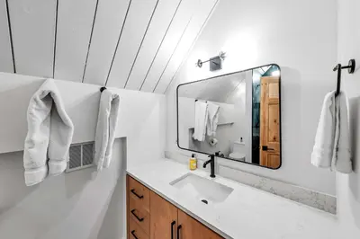 a bathroom with a sink and a mirror at Tahoe City Vacation Rental with Fireplace and Deck in Tahoe City