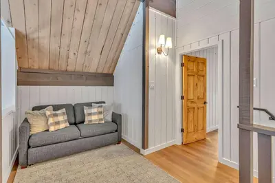 a living room with a couch and a wooden ceiling at Tahoe City Vacation Rental with Fireplace and Deck in Tahoe City