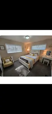 a bedroom with a large bed and a desk at Charming peaceful stay in Sacramento