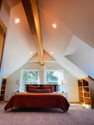 a bedroom with a large bed in a attic at Shaver Lake, 4 BDR HOT TUB Misty Mountain Retreat in Shaver Lake