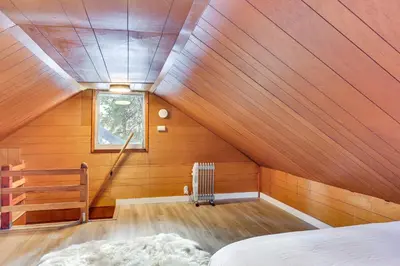 a attic room with a bed and a window at Less Than 2 Blocks to Lake Tahoe Family Home Near Skiing in Homewood