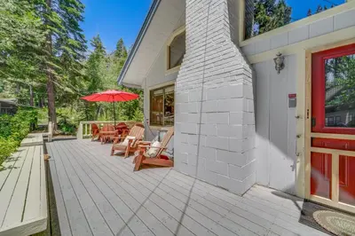a patio with chairs and an umbrella on a house at Less Than 2 Blocks to Lake Tahoe Family Home Near Skiing in Homewood