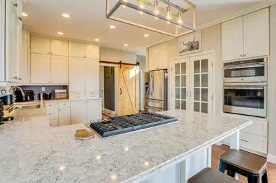 a kitchen with white cabinets and a counter top at Mtn-View Haven with Hot Tub! 28 Mi to Mt Rose Ski in Sparks
