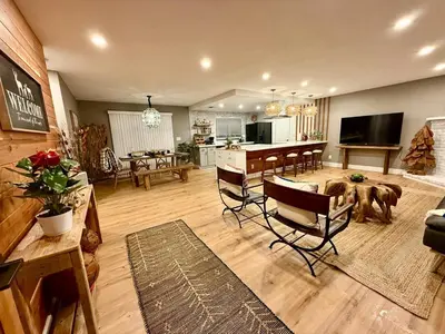 a living room with a table and chairs and a kitchen at The Ultimate Mountain Retreat close Yosemite and Bass Lake in Oakhurst