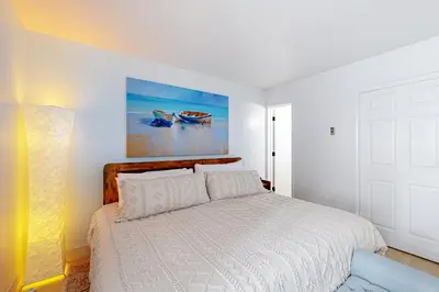 a bedroom with a bed and a painting on the wall at The Pines Chalet in Incline Village