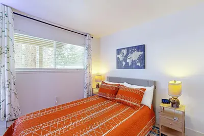 a bedroom with an orange bed and a window at The Pines Chalet in Incline Village