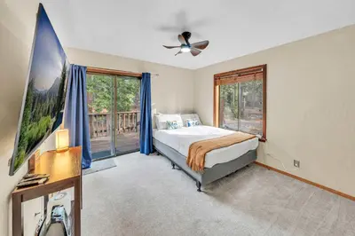 a bedroom with a bed and a large window at Cozy Kings Beach Vacation Rental with Deck in Kings Beach
