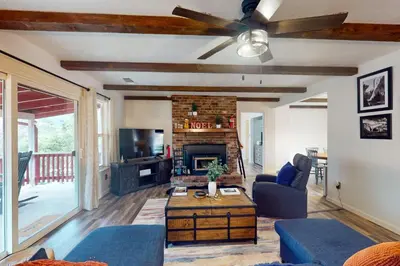 a living room with a couch and a fireplace at The Firelight Lodge in Oakhurst
