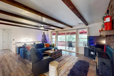a living room with a blue couch and a tv at The Firelight Lodge in Oakhurst