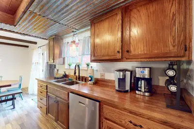 a kitchen with wooden cabinets and a counter top at The Firelight Lodge in Oakhurst