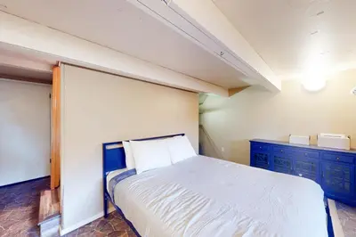 a bedroom with a white bed and blue cabinets at The Firelight Lodge in Oakhurst