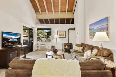 a living room with a couch and a fireplace at Lakeland Village 2 Bed Condo Pool View in South Lake Tahoe