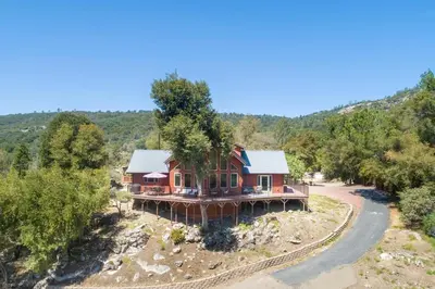 an aerial view of a house on a hill at Waterfall Lodge near Yosemite Endless Pool, Hot Tub, Playground in Oakhurst