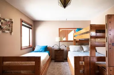 two beds in a room with two bunk beds at Waterfall Lodge near Yosemite Endless Pool, Hot Tub, Playground in Oakhurst