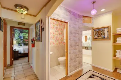 a bathroom with a toilet and a walk in shower at Steps to Truckee River Walk Rose Cottage in Reno