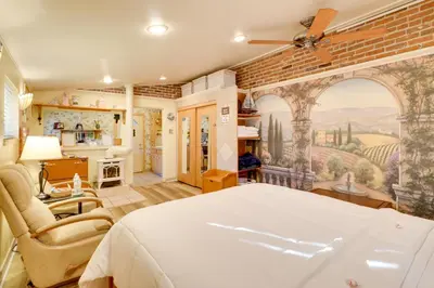 a bedroom with a bed and a brick wall at Close to Midtown! Cozy Reno River Cottage in Reno