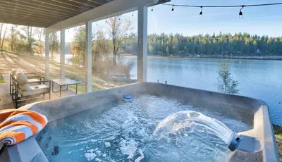 a jacuzzi tub with a view of a lake at Lakefront Villa with 180 degree view private dock and boats in Groveland