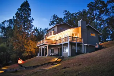 a large house on top of a hill at Lakefront Villa with 180 degree view private dock and boats in Groveland