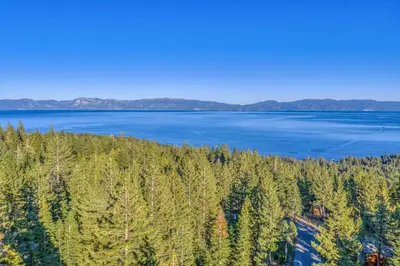 an aerial view of a lake with trees at Beautiful Homewood Retreat with Deck and Grill in Homewood