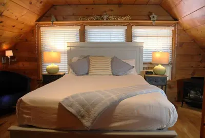 a bedroom with a large bed in a cabin at Elliott House Boutique Inn in Shaver Lake