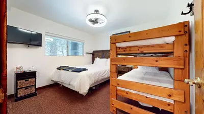 a bedroom with a bunk bed and a bedroom with a bed at Meridian Villas #10 condo in Mammoth Lakes
