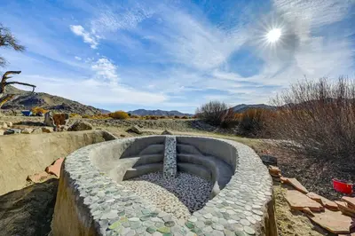 a stone fire pit in the middle of a field at Mtn-View Weldon Home Walk to Pacific Crest Trail in Weldon