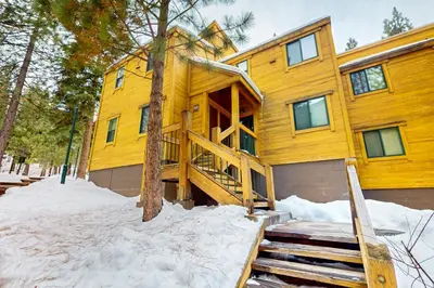 a wooden house in the snow in front at Northstar Retreat in Kingswood Estates