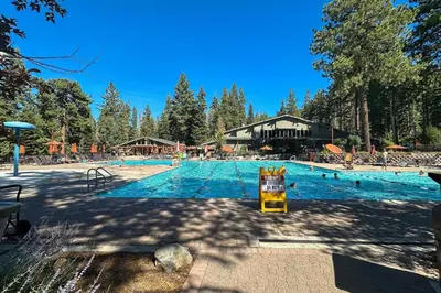 a large swimming pool with people in the water at Northstar Retreat in Kingswood Estates
