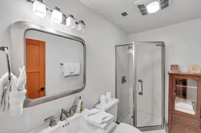 a bathroom with a sink and a shower and a mirror at Stunning Mountain Gem with Hot Tub Near Palisades in Olympic Valley