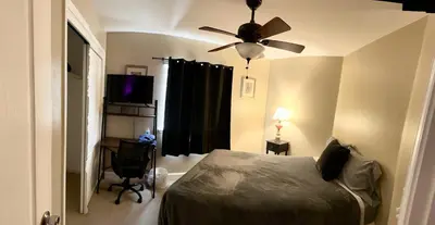 a bedroom with a bed and a ceiling fan at serenity in Fresno