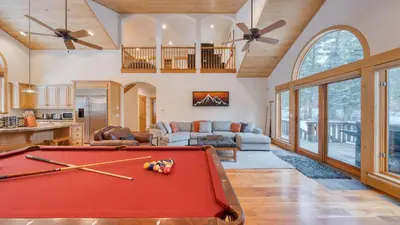 a living room with a pool table at 5 mins to Ski Resort Ping Pong Pool Table Deck Donner Ridge by AvantStay in Truckee