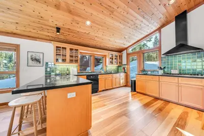 a kitchen with wooden ceilings and a wooden floor at Pet-Friendly Home, Deck, 1 Mile to Alpine Meadows in Alpine Meadows