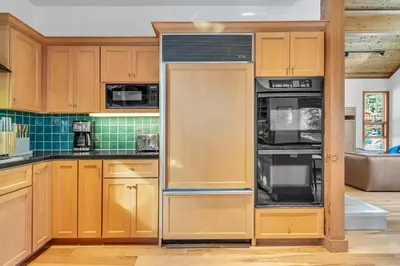 a large kitchen with wooden cabinets and appliances at Pet-Friendly Home, Deck, 1 Mile to Alpine Meadows in Alpine Meadows