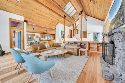 an open living room with a stone fireplace at Pet-Friendly Home, Deck, 1 Mile to Alpine Meadows in Alpine Meadows